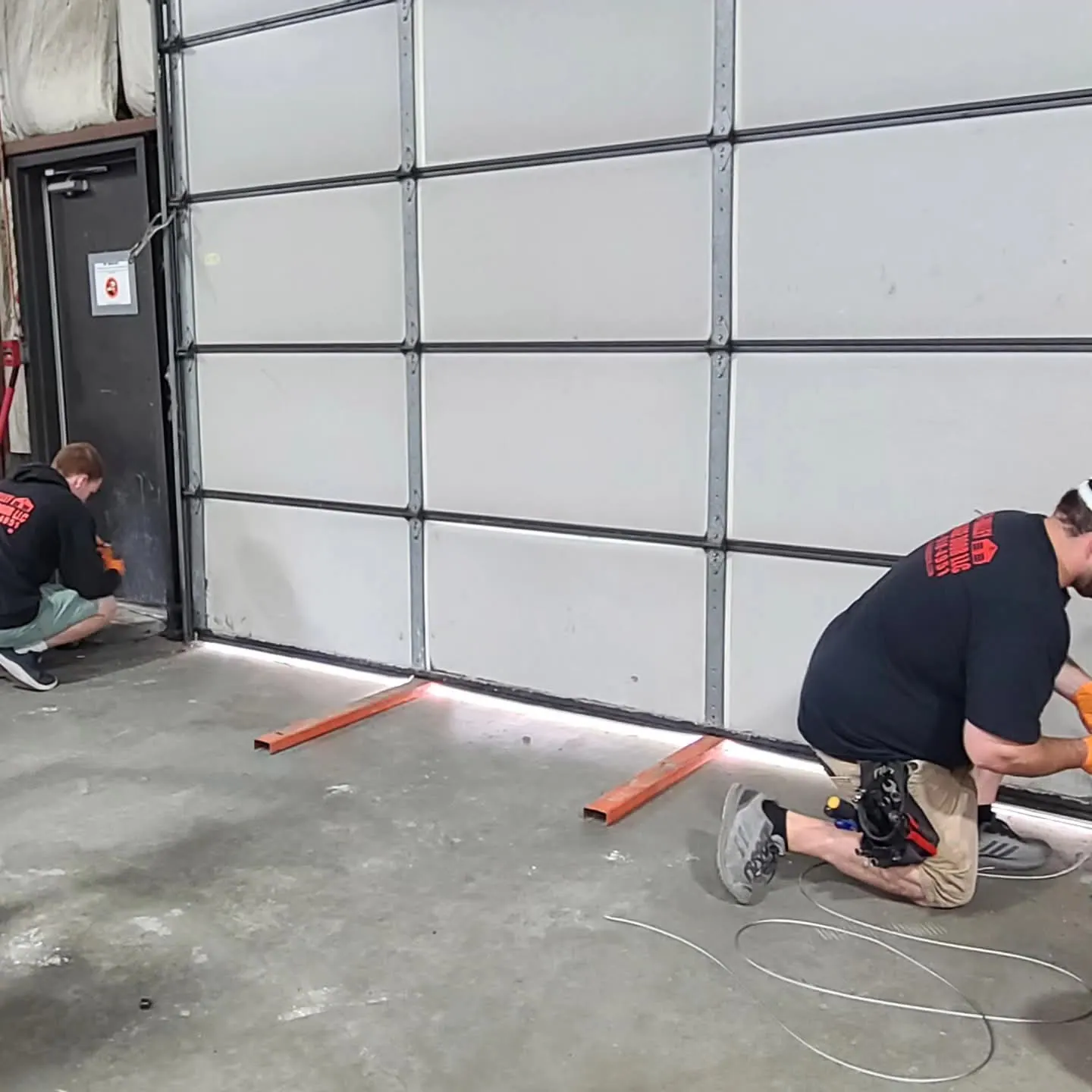 Crew servicing a commercial sectional door