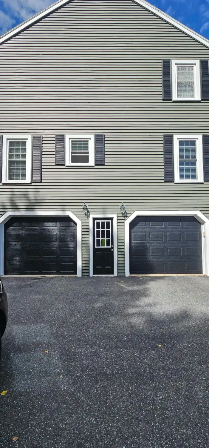 Dark carriage-style doors with iron-look hardware