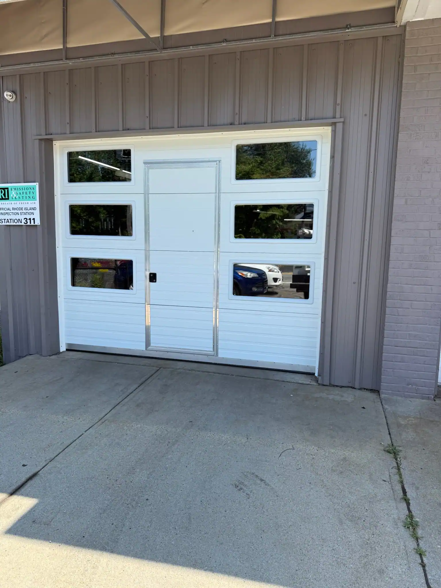 A glass sectional door with a pass-through entry