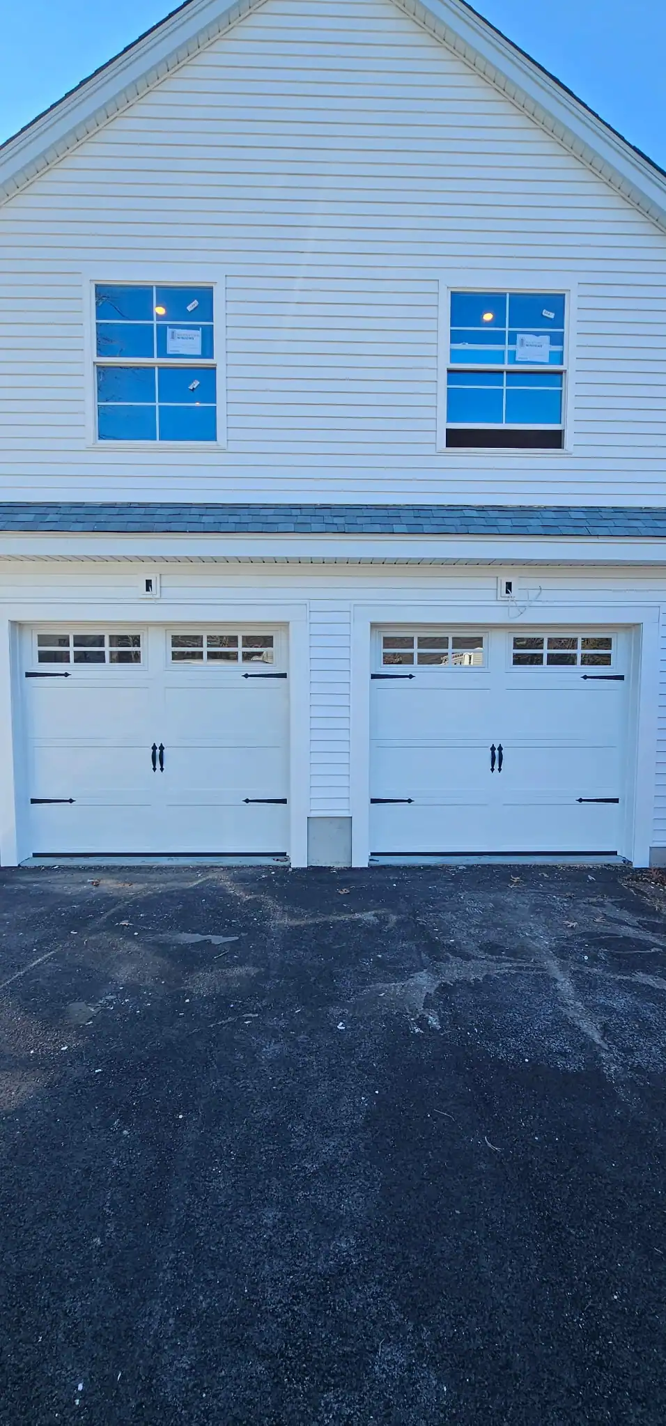Light blue carriage-style doors on a matching house