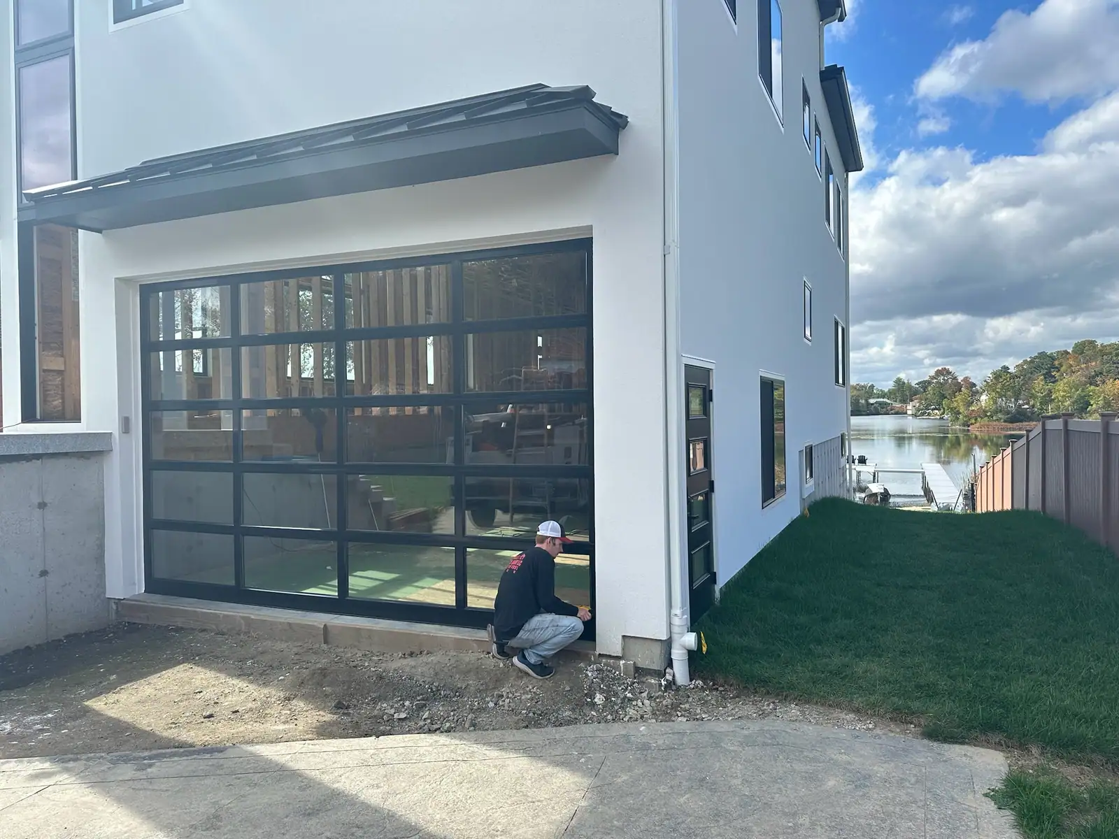 Setting a full-view glass door on a new lakeside build