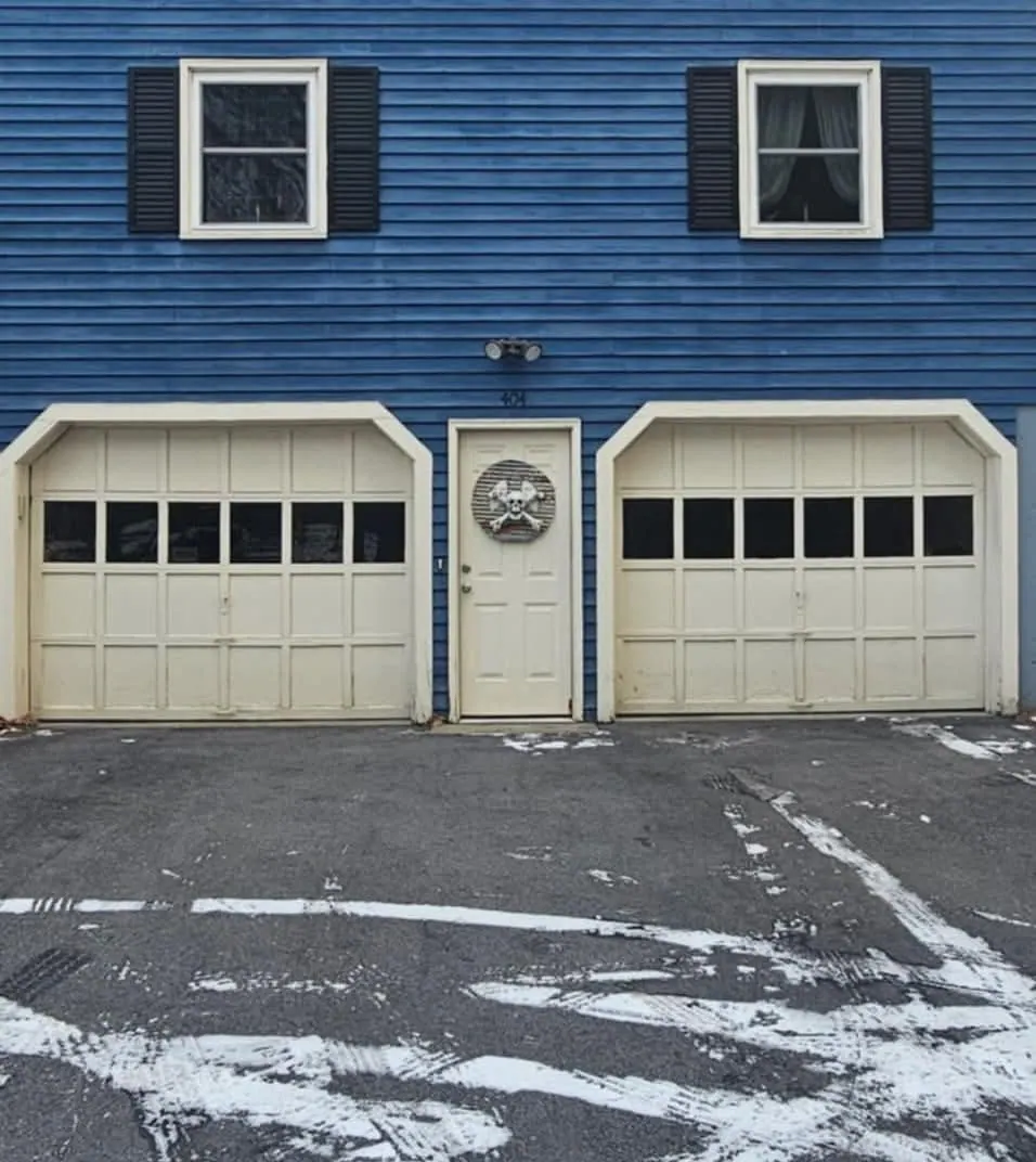 Tan carriage-style doors with a center entry door