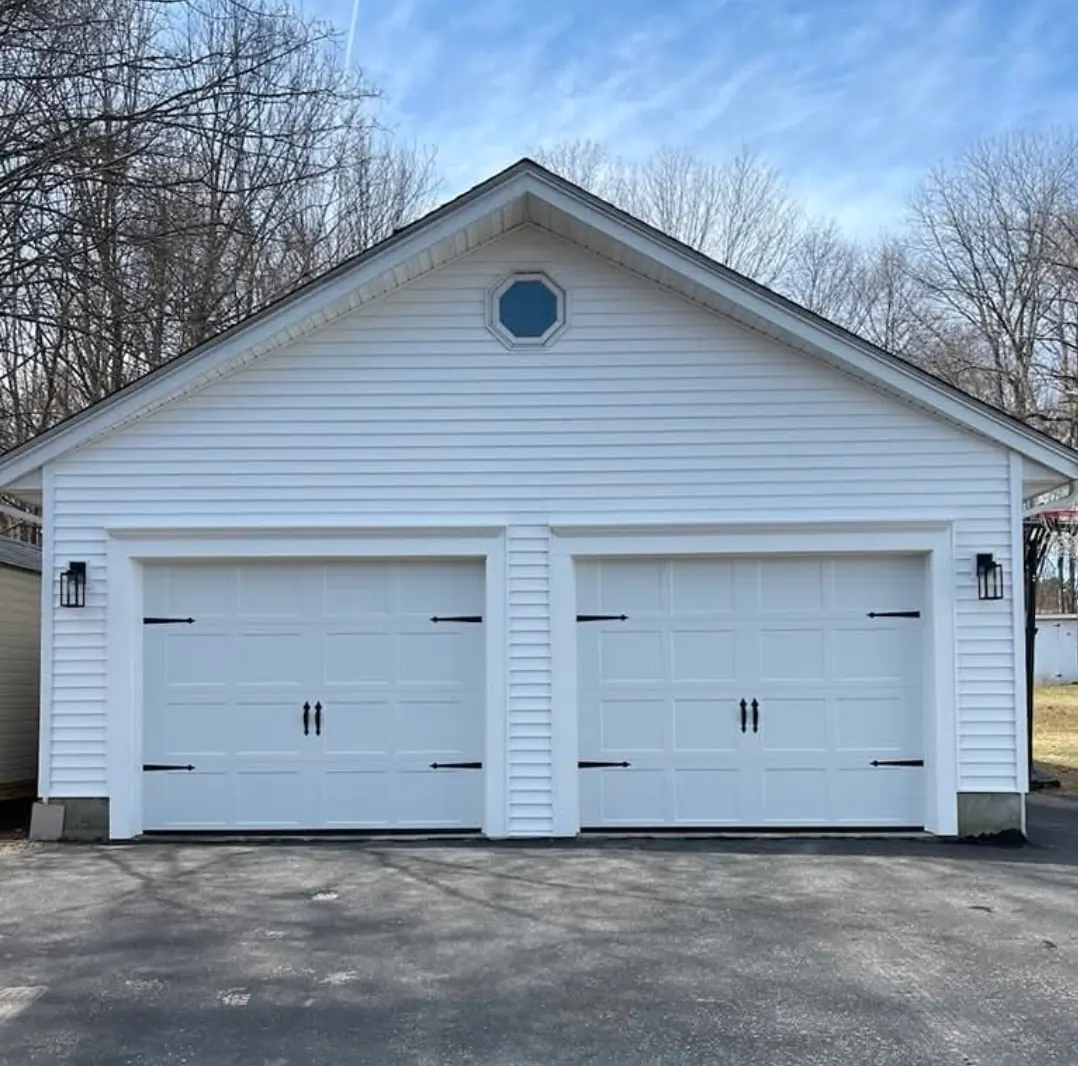 White carriage-style doors on a detached garage
