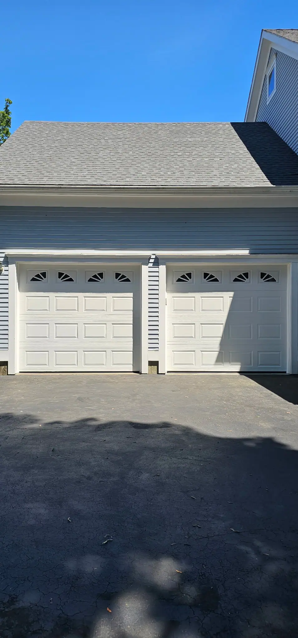 White carriage-style doors with sunburst windows
